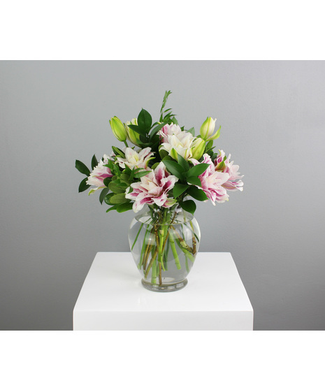 Lily Luxe is a stunning floral arrangement that embodies elegance and simplicity.