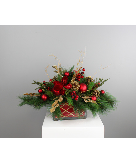 Gilded Evergreen Centerpiece brings refined holiday elegance to the table with warm metallic accents and lush seasonal texture.