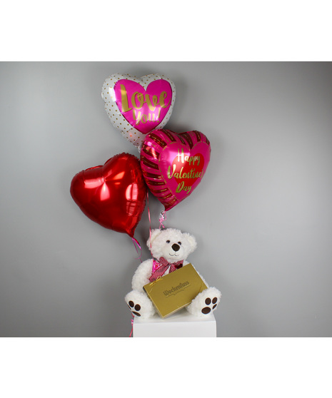 This stunning floral arrangement features a dozen vibrant hot pink roses elegantly arranged in a sleek clear glass vase.