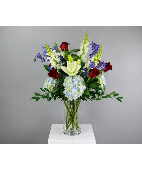 Patriotic Tribute is a bold and elegant floral arrangement designed to honor, celebrate, and remember with timeless beauty.